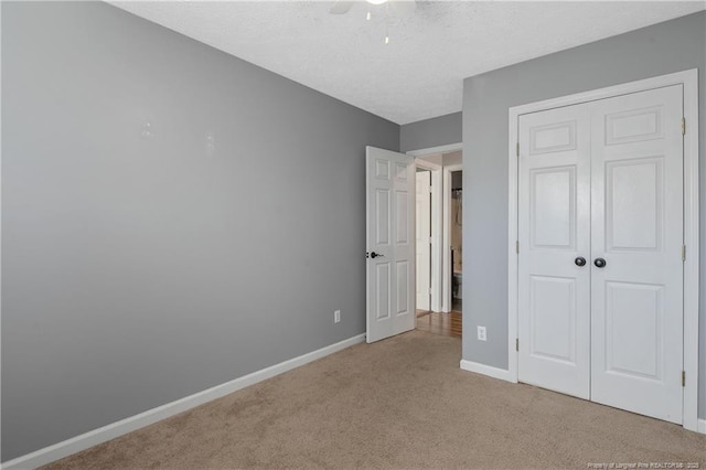 unfurnished bedroom featuring a closet, light carpet, and ceiling fan