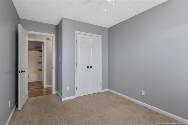 unfurnished bedroom featuring a closet and light carpet