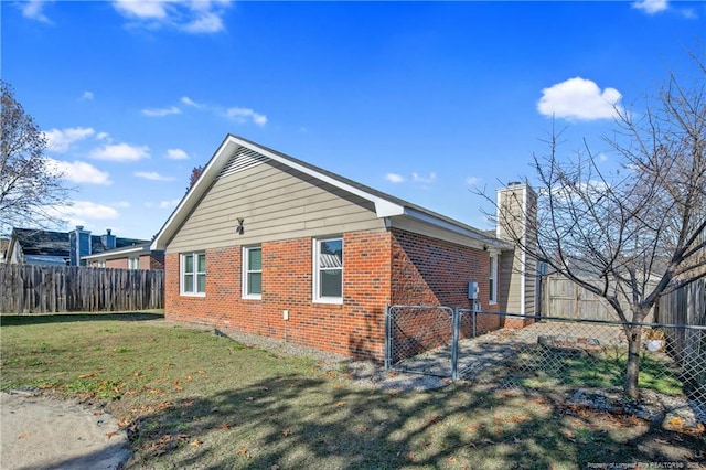 view of side of property with a lawn