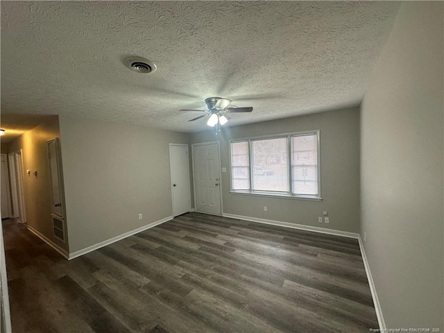 unfurnished bedroom with a textured ceiling, ceiling fan, and dark hardwood / wood-style floors