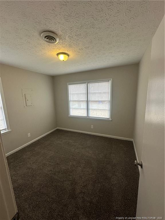 carpeted spare room featuring plenty of natural light