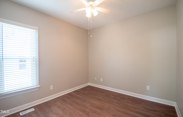 empty room featuring ceiling fan and dark hardwood / wood-style floors