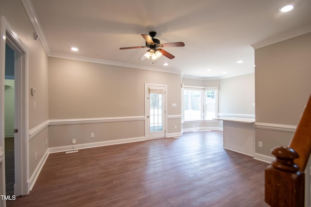 spare room featuring dark hardwood / wood-style flooring, ceiling fan, and ornamental molding