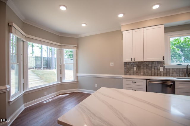 kitchen featuring sink, white cabinetry, dishwasher, decorative backsplash, and light stone countertops