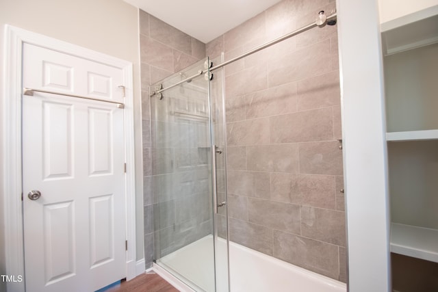 bathroom featuring walk in shower and hardwood / wood-style floors