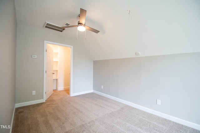 additional living space with ceiling fan, vaulted ceiling, and light carpet