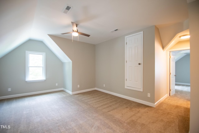 bonus room with vaulted ceiling, ceiling fan, and light carpet