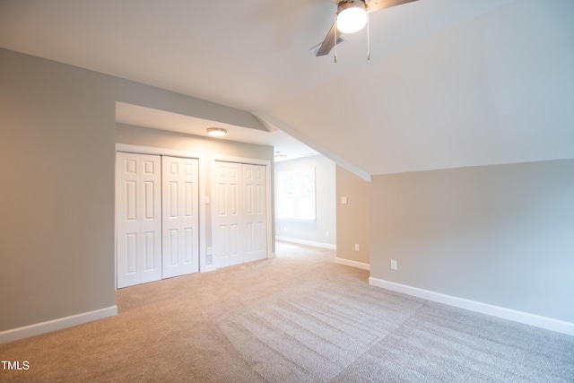 additional living space featuring ceiling fan, light carpet, and lofted ceiling