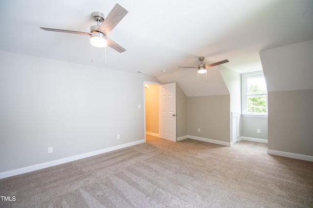 bonus room featuring light carpet, ceiling fan, and vaulted ceiling