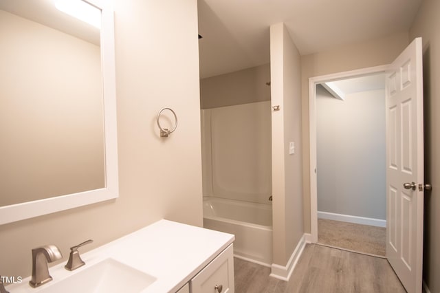 bathroom with vanity, hardwood / wood-style floors, and  shower combination