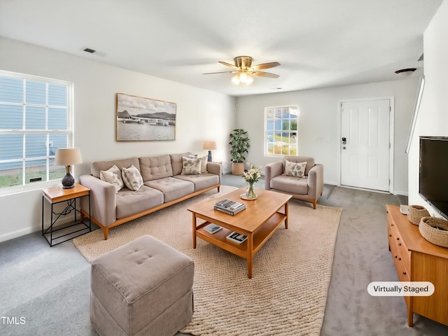 living room featuring carpet floors and ceiling fan