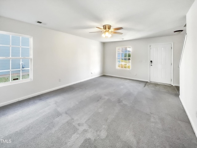 carpeted empty room featuring ceiling fan