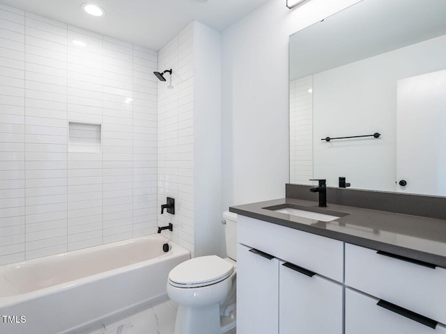 full bathroom with toilet, vanity, and tiled shower / bath combo