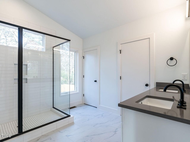 bathroom with vaulted ceiling, vanity, and a shower with shower door