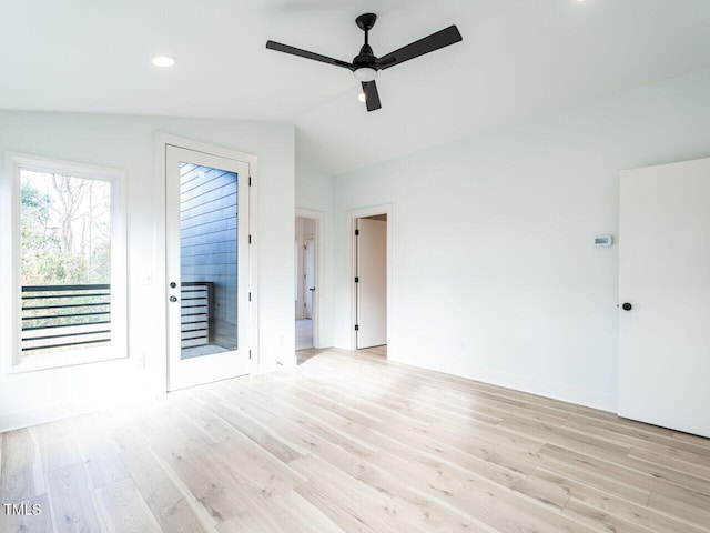 spare room featuring lofted ceiling, ceiling fan, and light hardwood / wood-style flooring