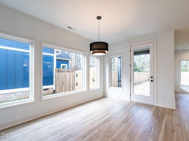 unfurnished dining area with light hardwood / wood-style flooring and a wealth of natural light