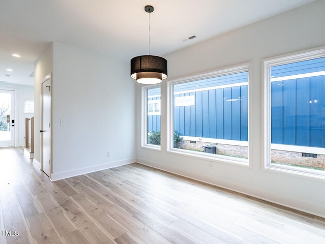 spare room with light hardwood / wood-style flooring