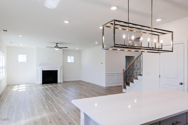 interior space with ceiling fan and light hardwood / wood-style floors