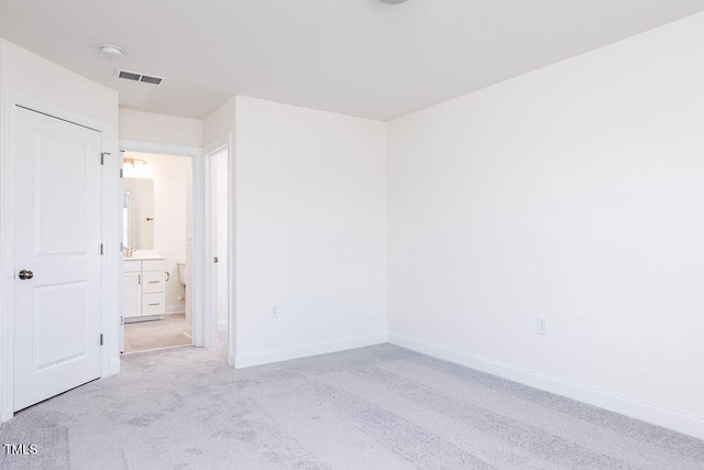 spare room with light colored carpet