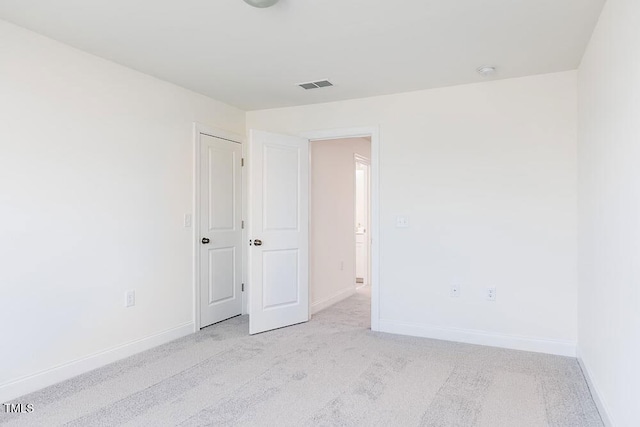 empty room featuring light carpet