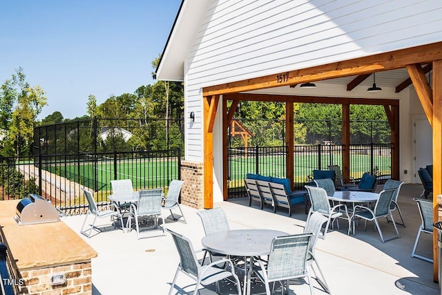 view of patio featuring ceiling fan and a grill