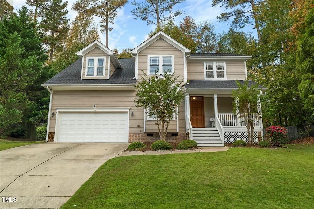 view of front of property with a garage, a front yard, and a porch