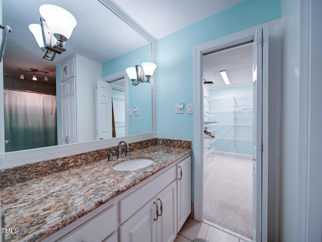 bathroom featuring vanity, tile patterned floors, an inviting chandelier, and a shower with shower curtain