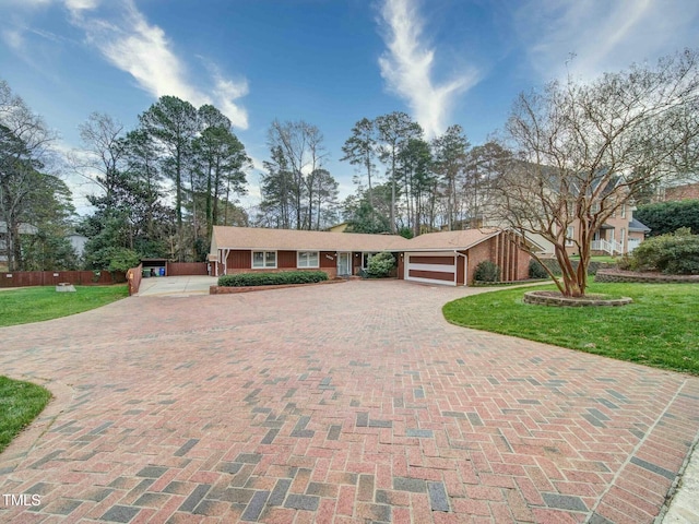 single story home featuring a garage and a front lawn