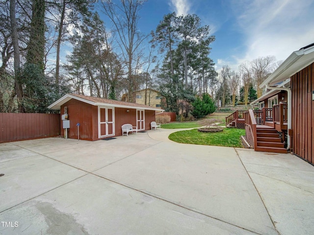 exterior space with a deck and a storage unit