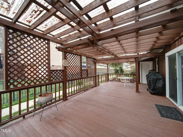 wooden deck with grilling area and a pergola