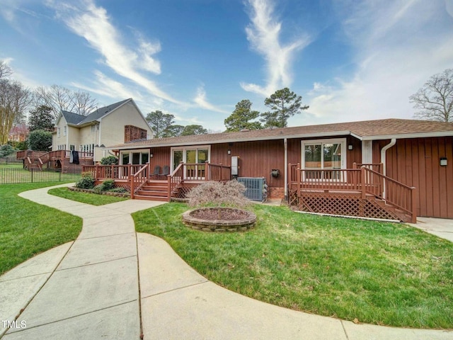 view of front facade featuring a front yard, central AC unit, and a deck