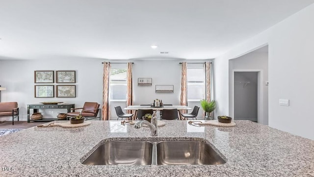 kitchen with light stone countertops and sink