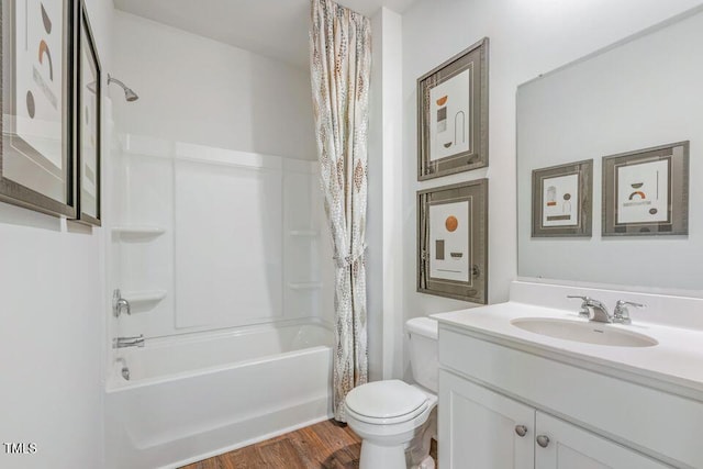 full bathroom with toilet, shower / bath combo with shower curtain, wood-type flooring, and vanity