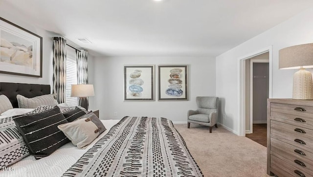 bedroom featuring carpet floors and a spacious closet