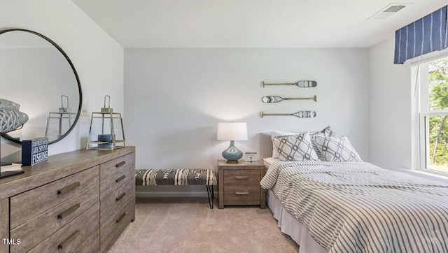 bedroom featuring light carpet and multiple windows