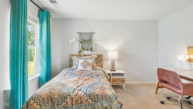 carpeted bedroom featuring multiple windows