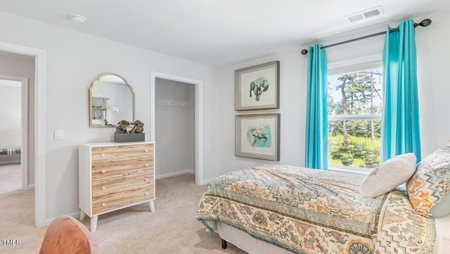 bedroom with light colored carpet and a closet