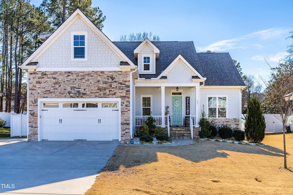 craftsman-style home with a garage and covered porch