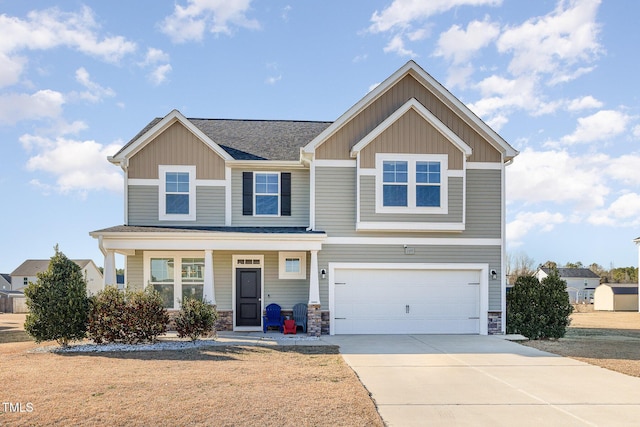 view of front of house featuring a garage, covered porch, and a front lawn