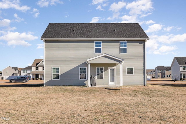 back of house with a yard