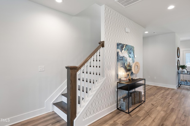 stairs featuring hardwood / wood-style flooring