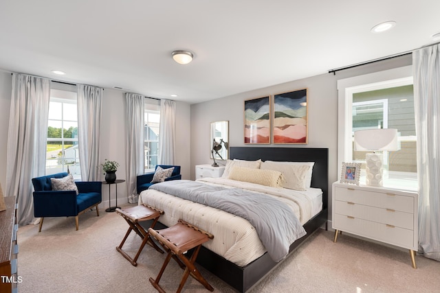 bedroom featuring light colored carpet