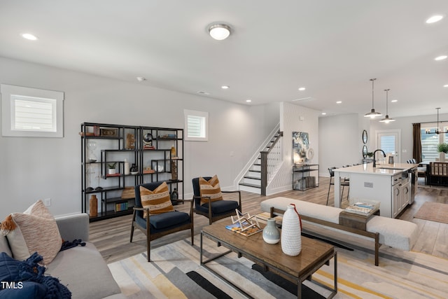 living room with light hardwood / wood-style floors and sink