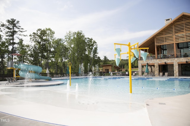 view of pool featuring pool water feature and a water slide