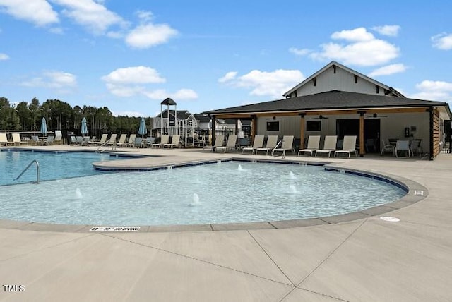 view of pool featuring pool water feature and a patio area