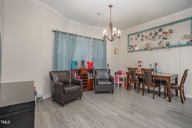 sitting room with crown molding, light hardwood / wood-style flooring, and a chandelier