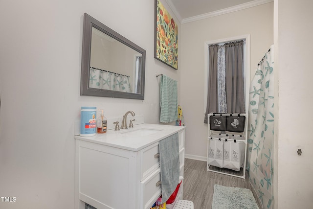 bathroom featuring ornamental molding, vanity, and hardwood / wood-style floors