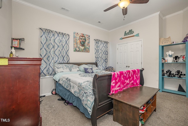 bedroom featuring carpet floors, ceiling fan, crown molding, and a closet