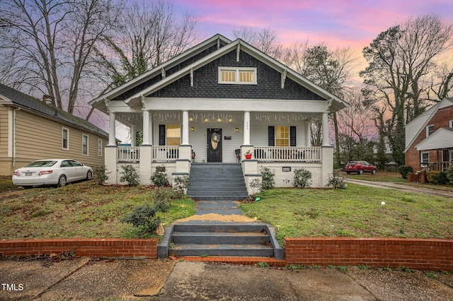 view of front of house featuring a yard and a porch