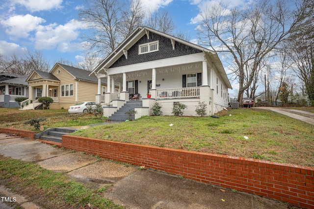 bungalow-style home featuring a porch and a front lawn